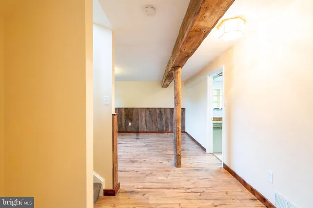 a view of a hallway with wooden floor