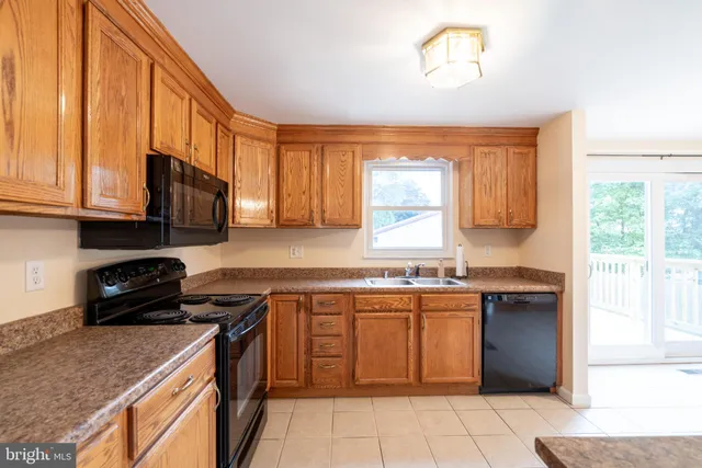 a kitchen with a stove a sink and a microwave