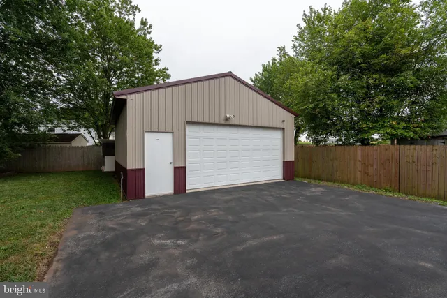a large room with chandelier fan and windows