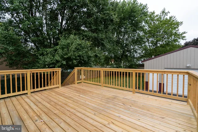 a view of balcony with wooden floor and fence