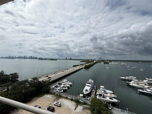 a spacious bedroom with a bed a flat screen tv and a couch