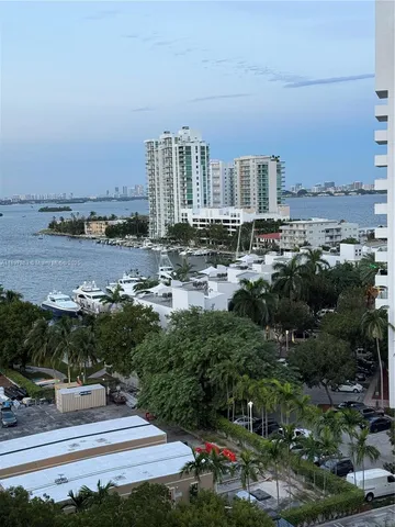 a view of a city with tall buildings and a big yard