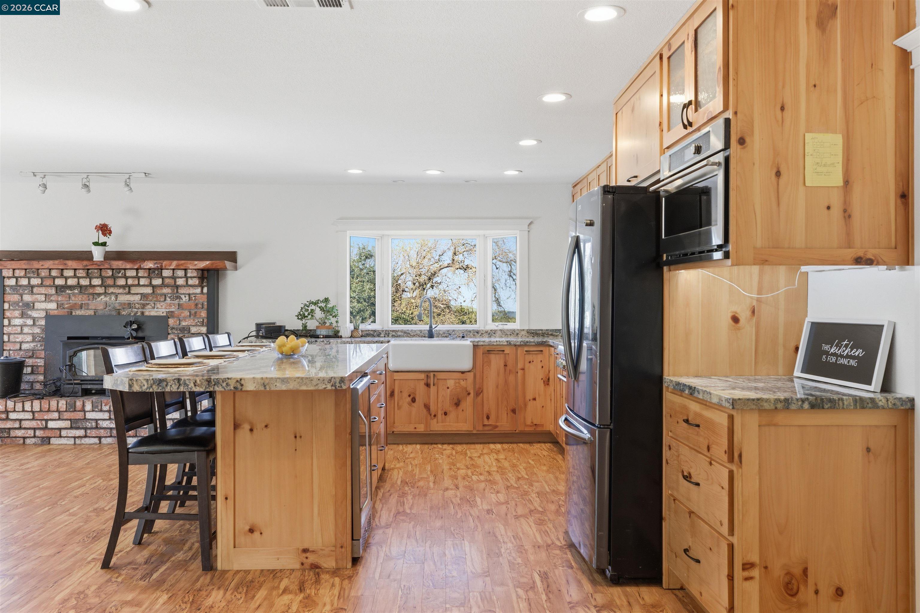 9530 Morgan Territory Road Livermore, CA 94551 - Photo 12 of 55 a kitchen that has a lot of cabinets a sink and a refrigerator