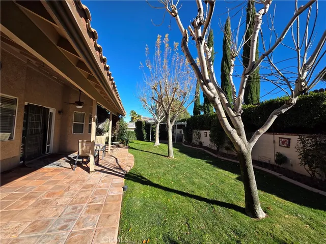 a view of a backyard with sitting area