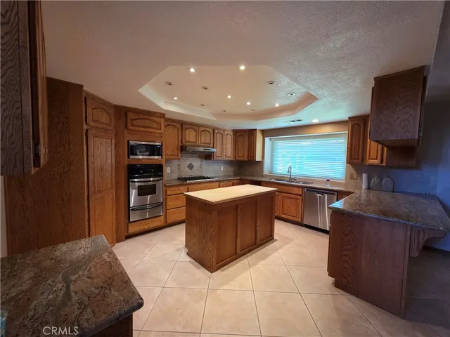 a kitchen with stainless steel appliances granite countertop a stove and a refrigerator