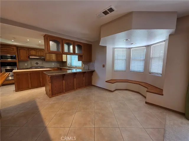 a kitchen with stainless steel appliances granite countertop a sink and cabinets