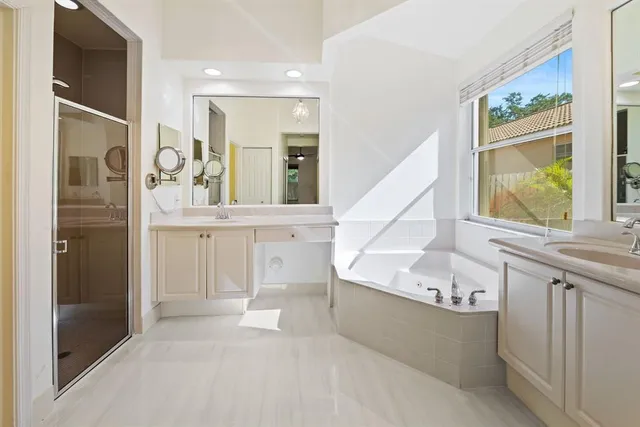 a spacious bathroom with a tub and a sink
