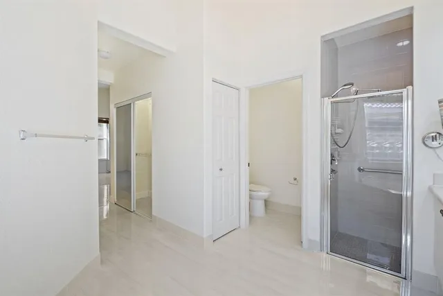 a bathroom with a granite countertop toilet and shower