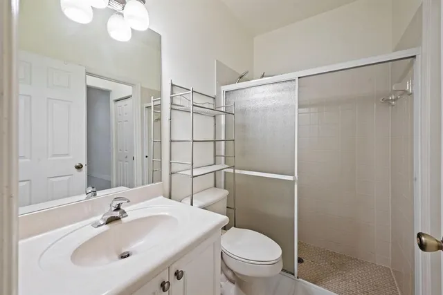 a bathroom with a sink toilet and shower