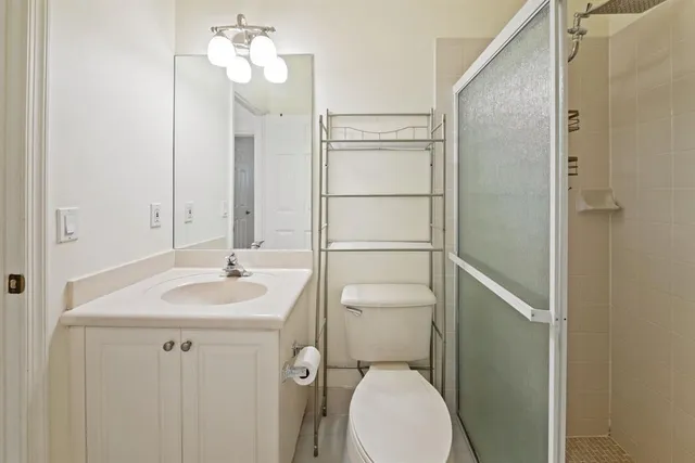 a bathroom with a sink toilet and shower