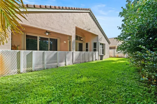 a front view of a house with a garden and yard
