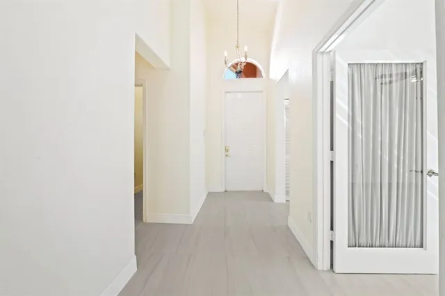 a view of a room with a white door and wooden floor