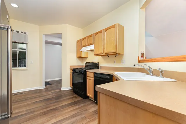 a kitchen with a sink stove and refrigerator