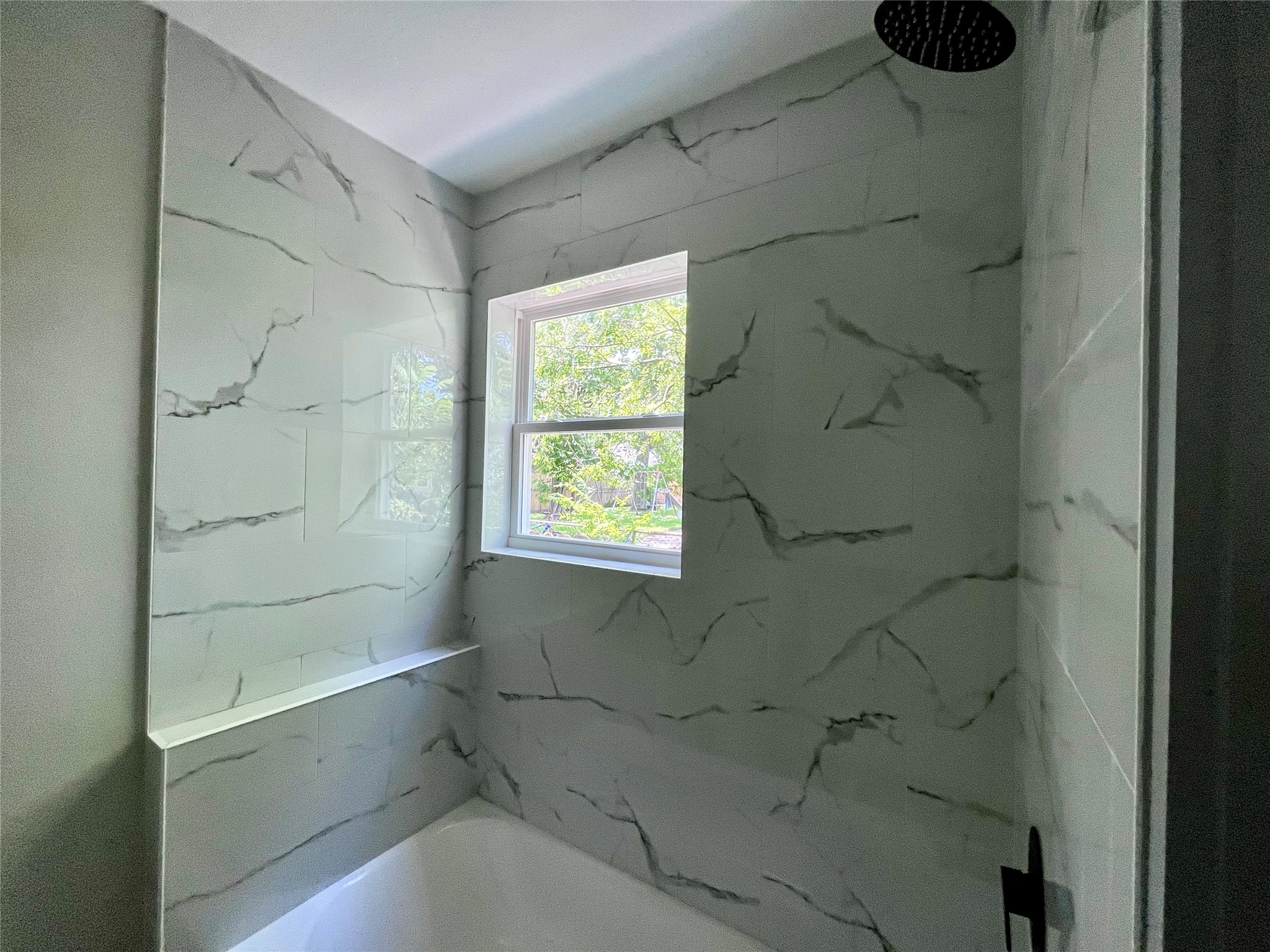 8335 Bonner Drive, Unit 1 Houston, TX 77017 - Photo 3 of 7 a bathroom with a bathtub