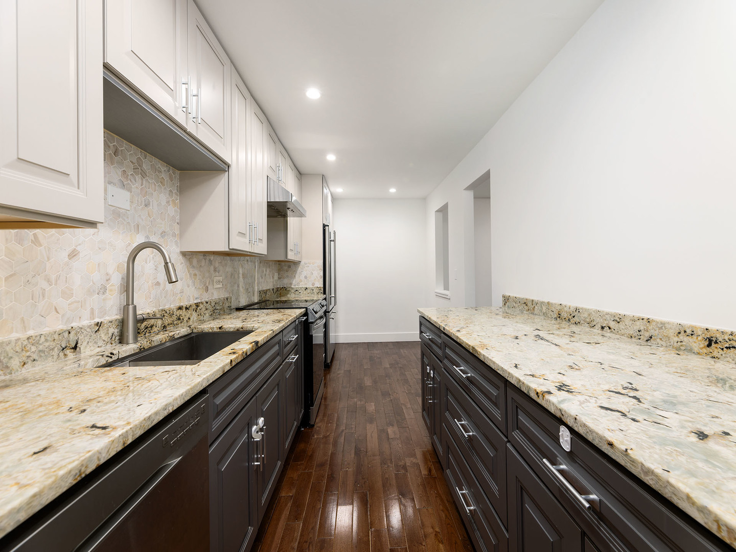 2315 East Olive Street, Unit 2B Arlington Heights, IL 60004 - Photo 12 of 30 a kitchen with granite countertop a sink stove and cabinets