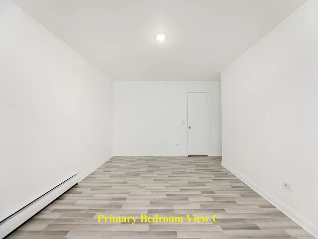 a view of an empty room and wooden floor