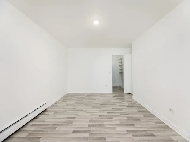 a view of walk in closet with empty racks