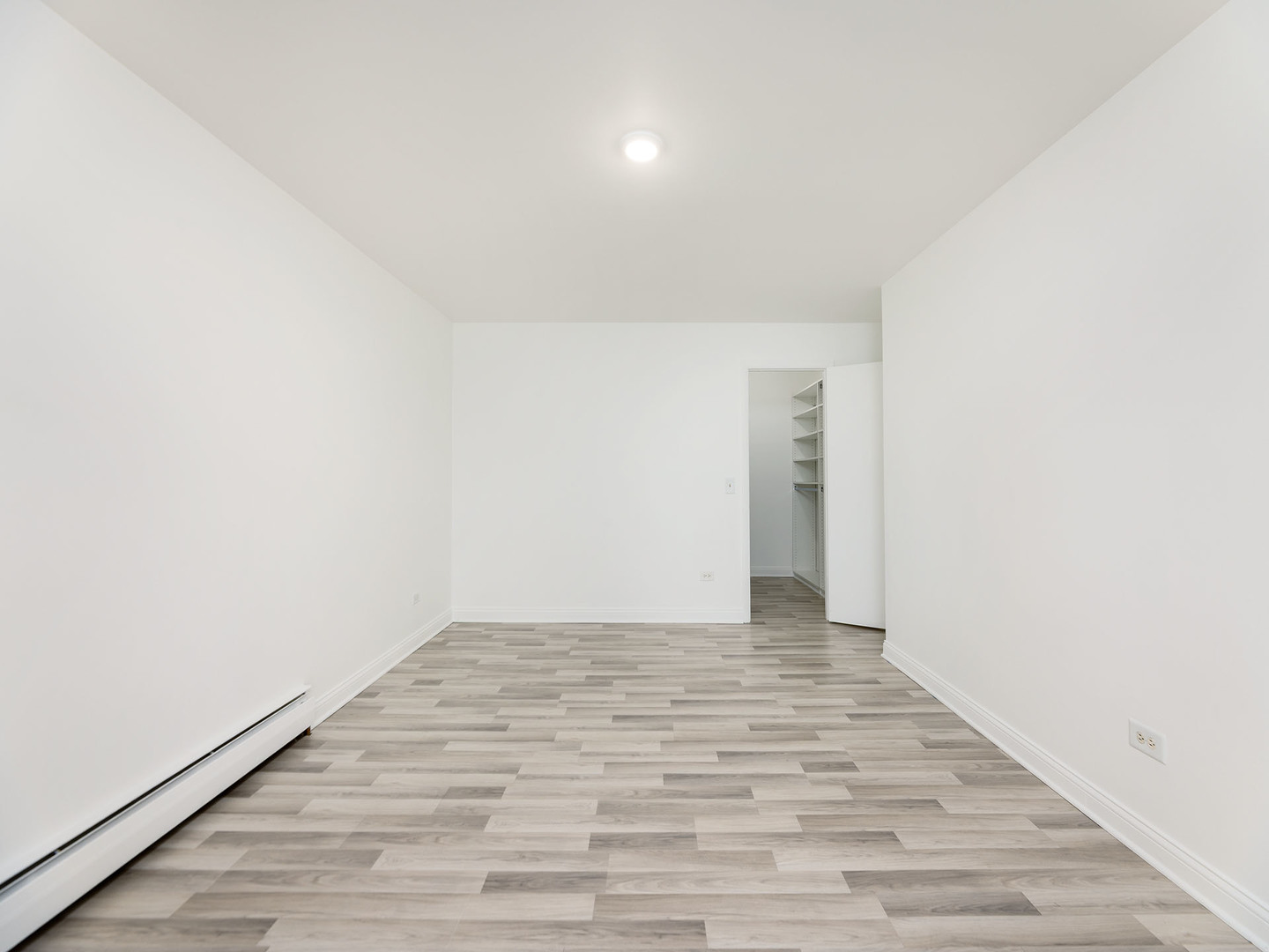 2315 East Olive Street, Unit 2B Arlington Heights, IL 60004 - Photo 19 of 30 a view of an empty room and wooden floor