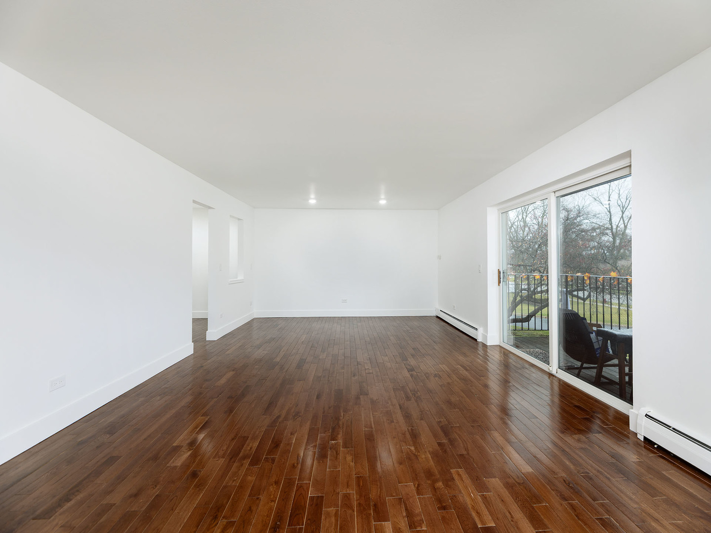 2315 East Olive Street, Unit 2B Arlington Heights, IL 60004 - Photo 4 of 30 wooden floor in an empty room with a window