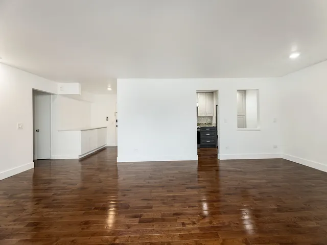 a kitchen with stainless steel appliances a refrigerator and a stove top oven