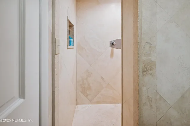 a bathroom with a granite countertop toilet and a sink