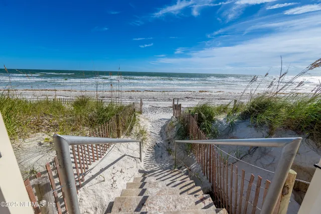 a view of a balcony with wooden fence