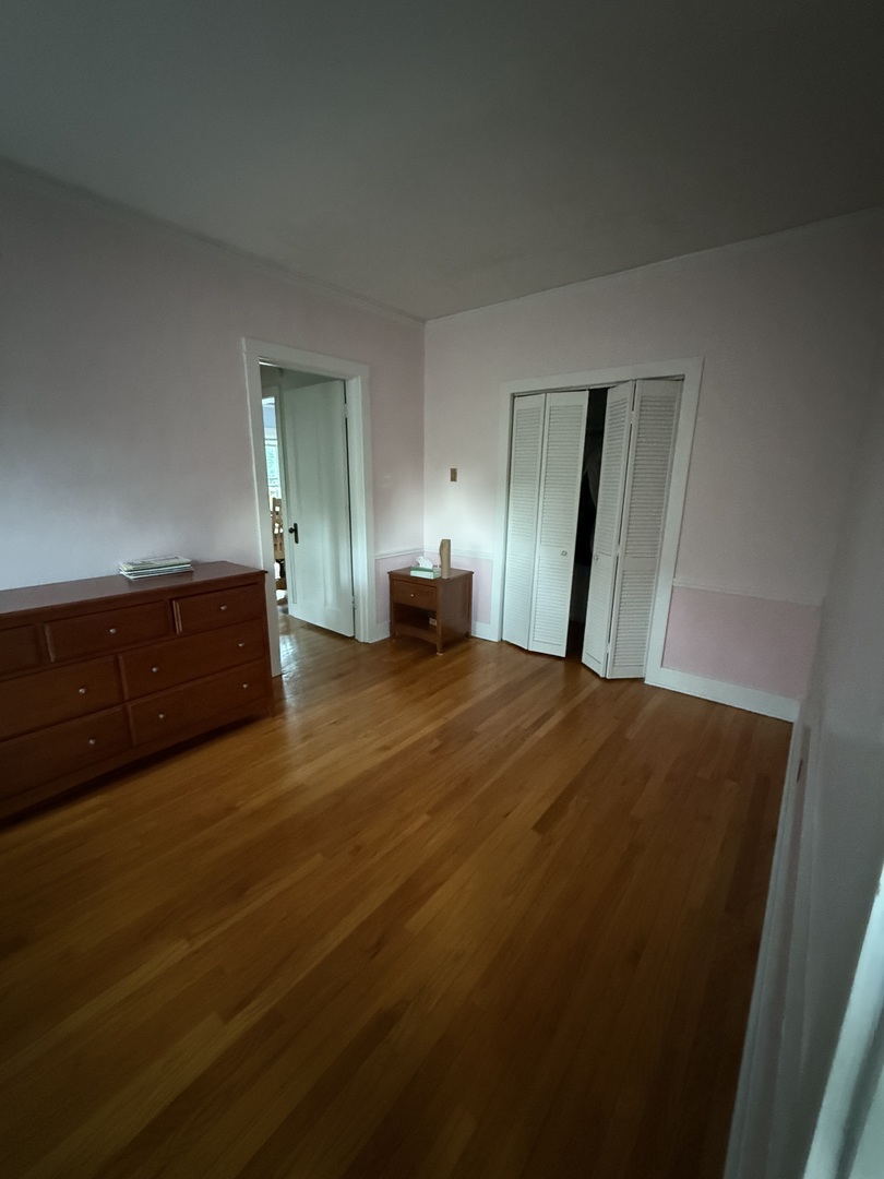 706 South Coler Avenue, Unit 5 Urbana, IL 61801 - Photo 12 of 21 a bedroom with a bed and a dresser