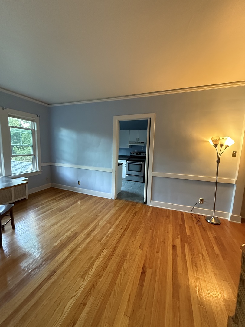 706 South Coler Avenue, Unit 5 Urbana, IL 61801 - Photo 17 of 21 a room with a bed and lots of wooden floor