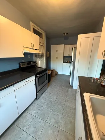 a kitchen with stainless steel appliances a sink stove and cabinets