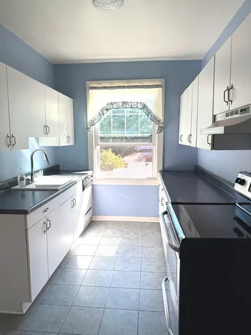 a large kitchen with a large window