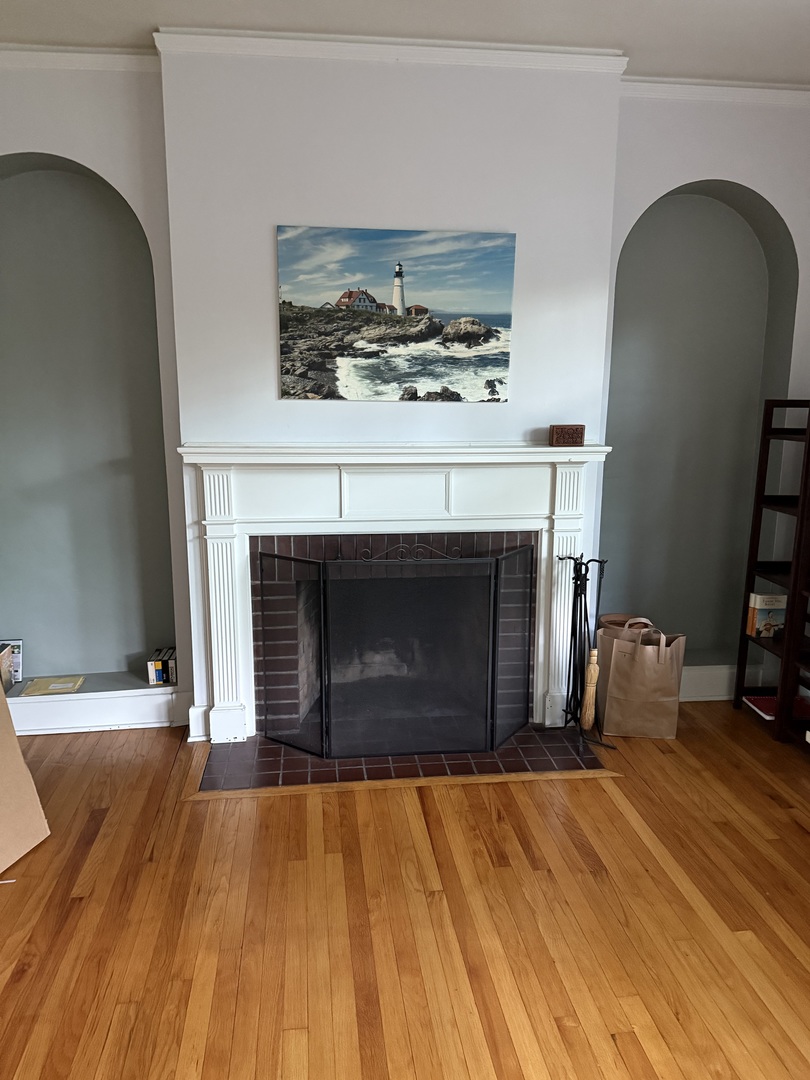 706 South Coler Avenue, Unit 5 Urbana, IL 61801 - Photo 5 of 21 a room with a fireplace and a wooden floor