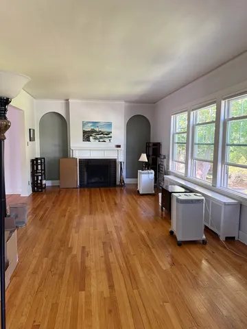 a living room with furniture and a wooden floor