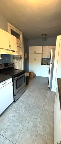 a view of a kitchen with a sink and an oven