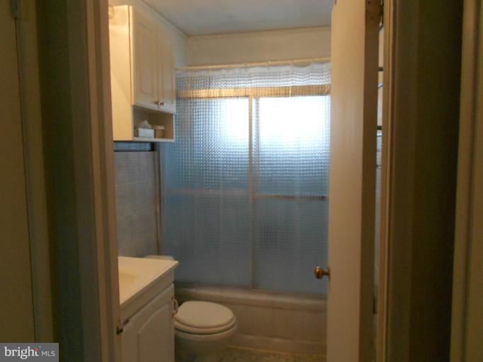 5901 Robindale Road Catonsville, MD 21228 - Photo 11 of 15 a bathroom with a shower a toilet and a window