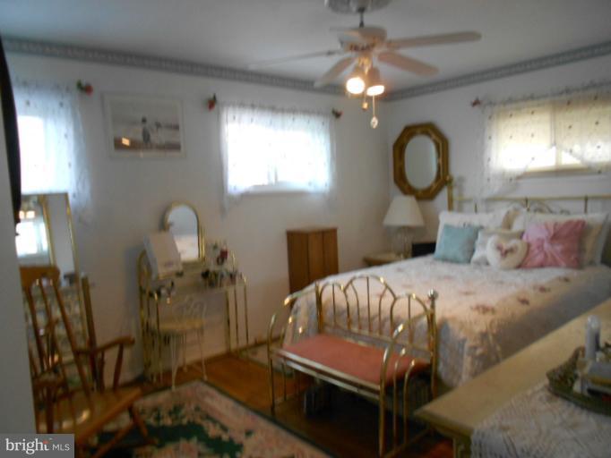 5901 Robindale Road Catonsville, MD 21228 - Photo 12 of 15 a bedroom with a bed and wooden floor