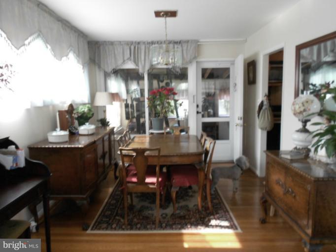 5901 Robindale Road Catonsville, MD 21228 - Photo 4 of 15 a view of a dining room with furniture window and wooden floor