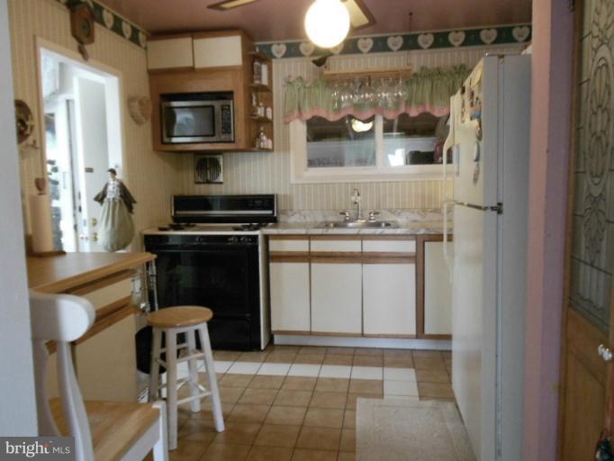 5901 Robindale Road Catonsville, MD 21228 - Photo 5 of 15 a kitchen with a stove and a microwave