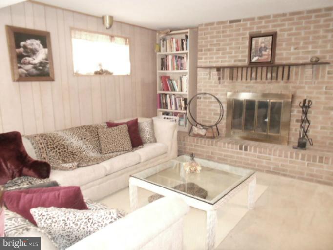 5901 Robindale Road Catonsville, MD 21228 - Photo 8 of 15 a living room with furniture a table and a chandelier