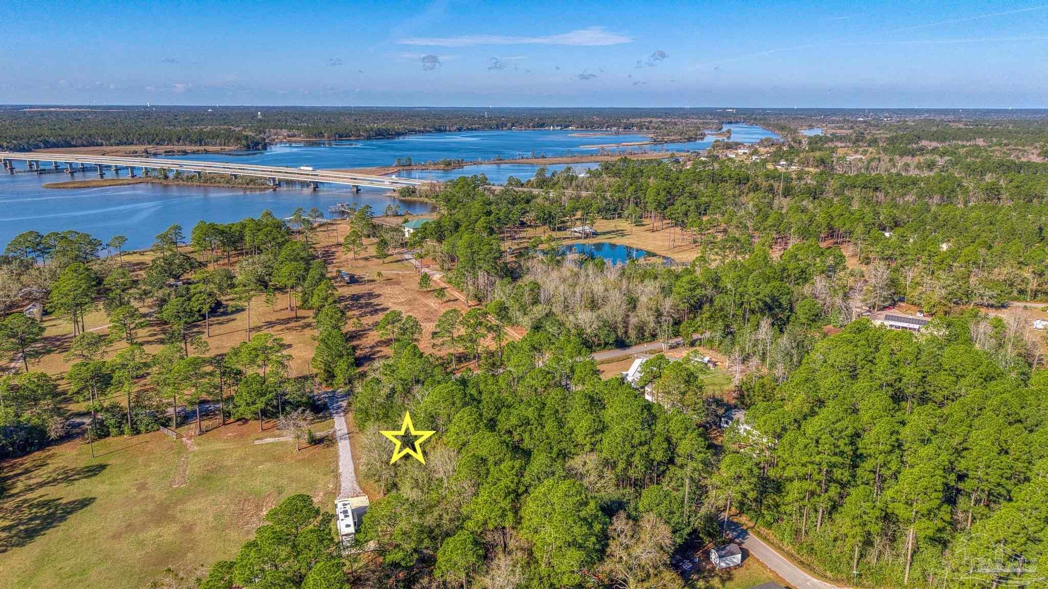 2 Petersen Point Road Milton, FL 32583 - Photo 11 of 15 a view of a lake with a yard