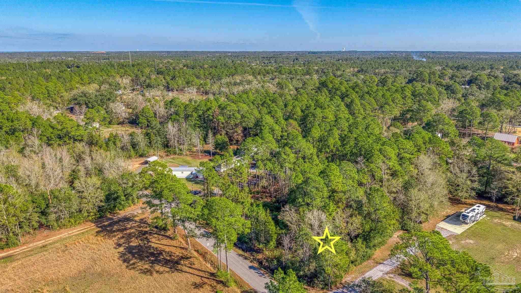 2 Petersen Point Road Milton, FL 32583 - Photo 9 of 15 a view of a yard with an outdoor space and seating area