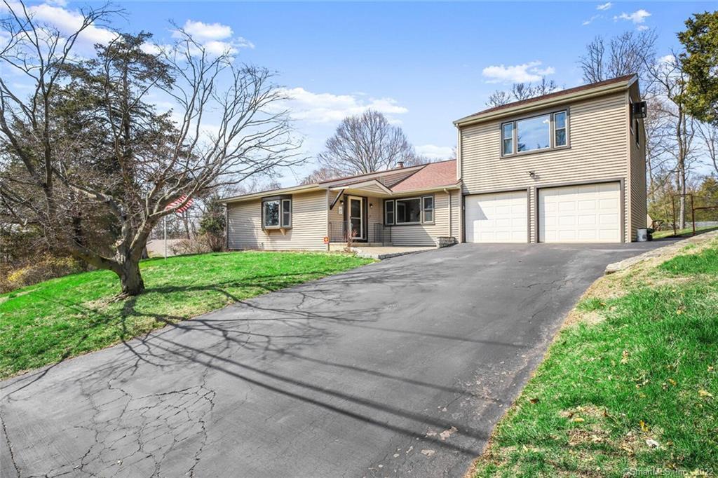 97 Ceil Road Trumbull, CT 06611 - Photo 1 of 1 a front view of a house with a yard and garage