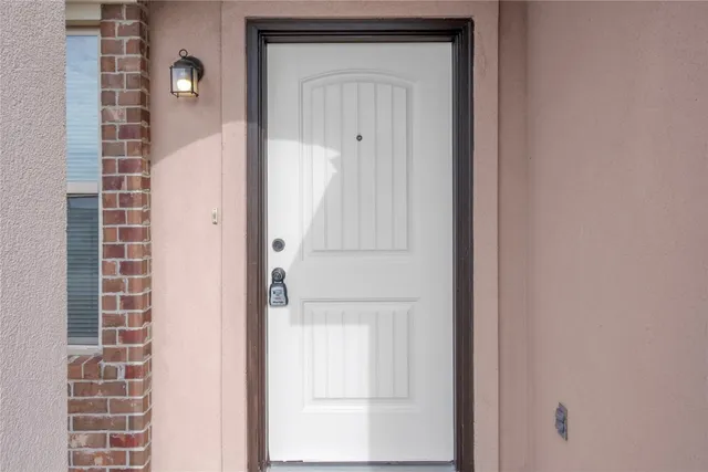 a view of a room with wooden floor and a ceiling fan