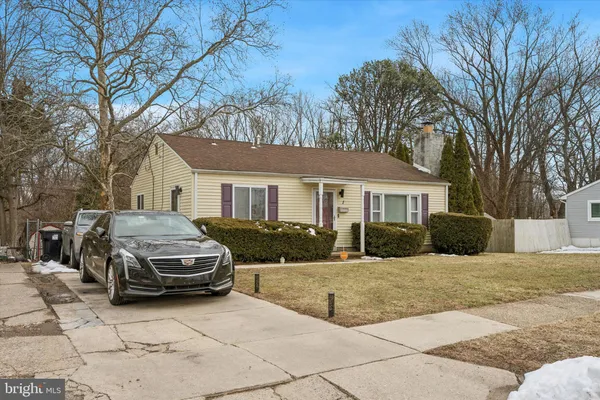 a car parked in front of a white house