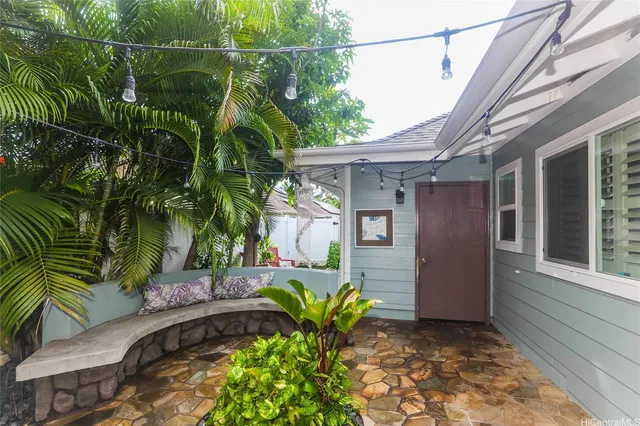 a view of backyard with plants and outdoor seating