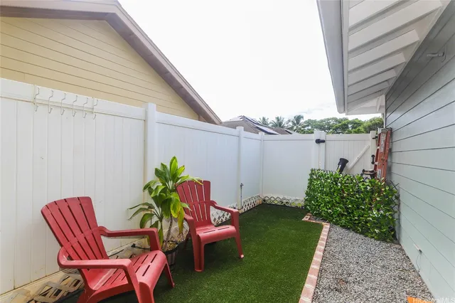 a backyard of a house with table and chairs