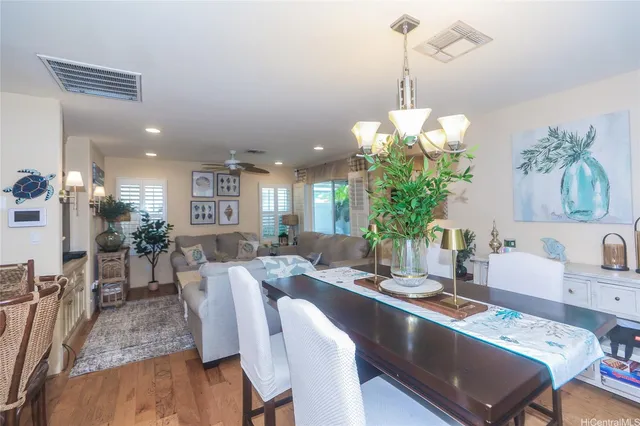 a view of a dining room with furniture wooden floor and chandelier