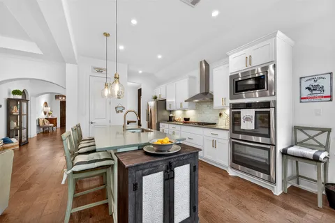 a kitchen with stainless steel appliances a stove a sink and a refrigerator