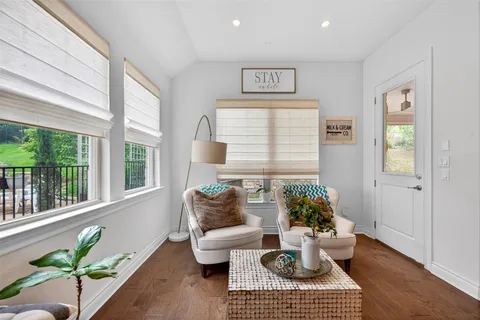 a living room with furniture and a potted plant