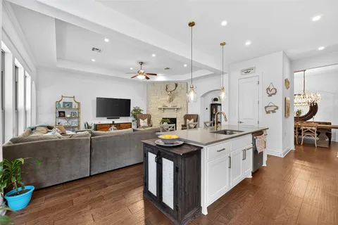 a kitchen with stainless steel appliances granite countertop a stove and a wooden floors