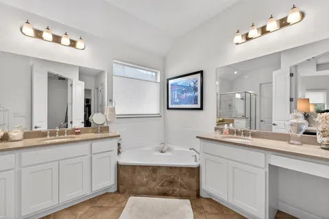 a bathroom with a sink double vanity granite and a mirror